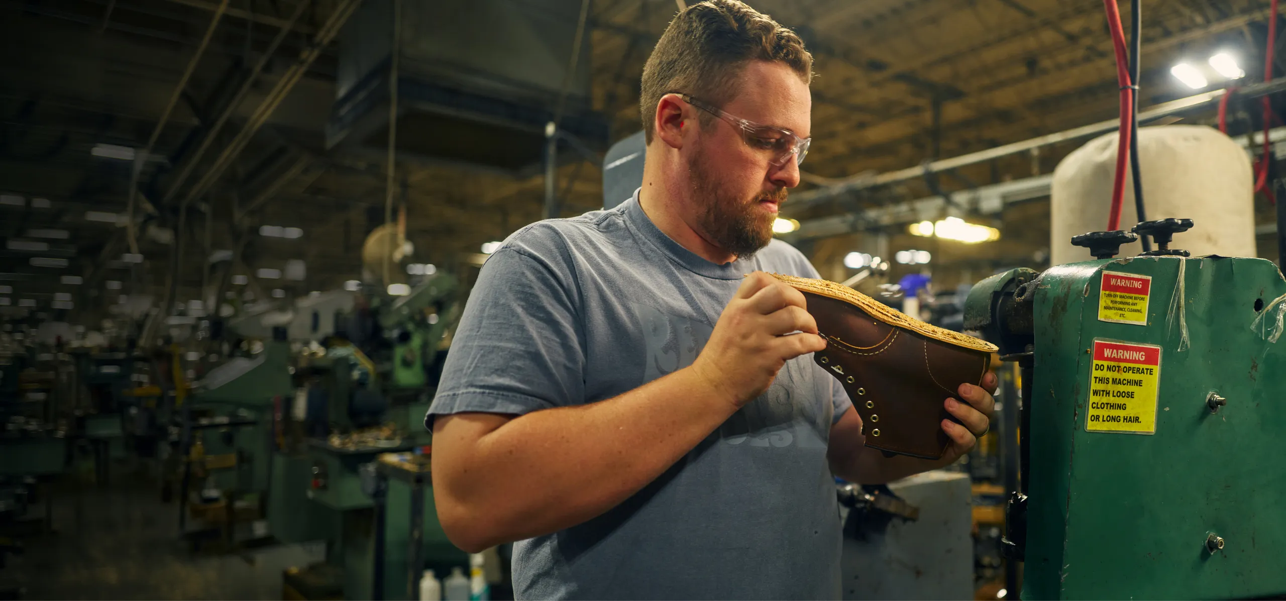 A craftsperson making a Red Wing boot